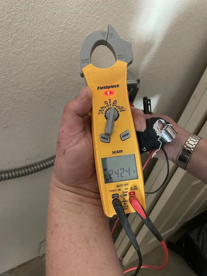 Voltage testing with clamp meter during Recessed Lighting Installation in Newbern